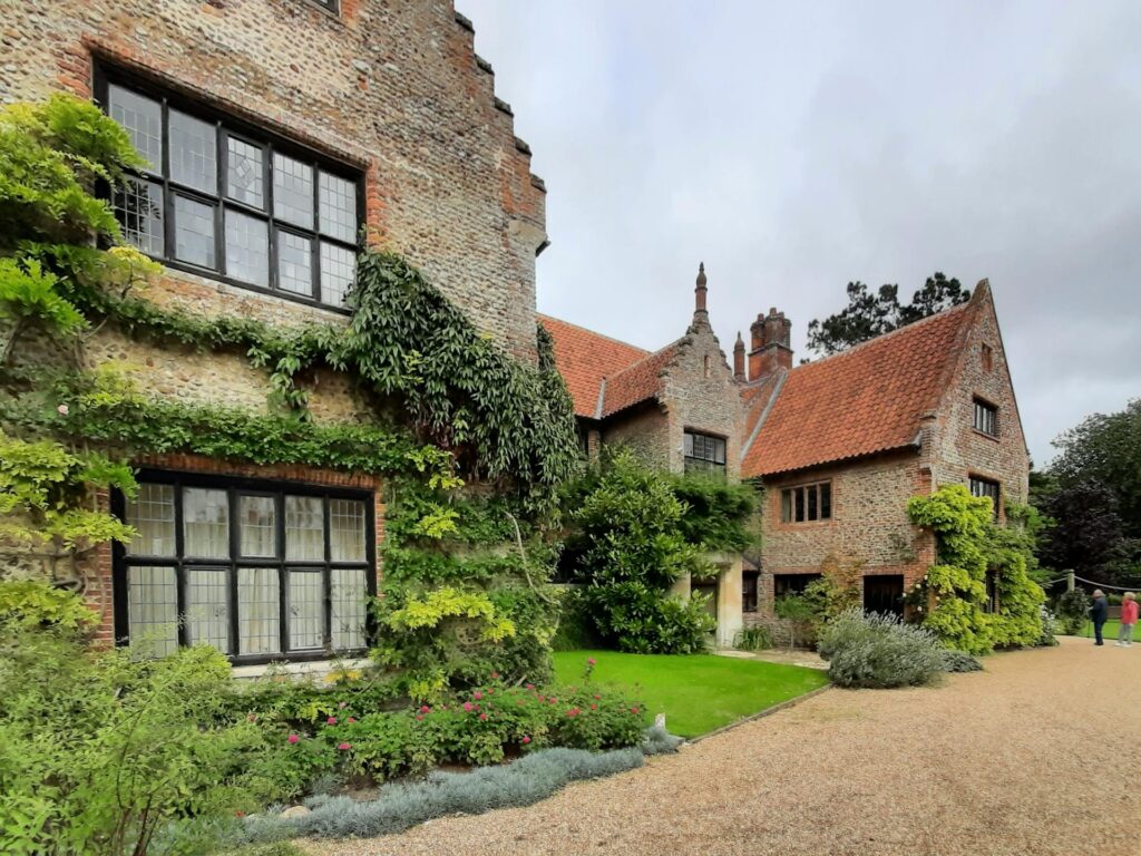 Charming historic manor in the countryside surrounded by lush greenery and garden