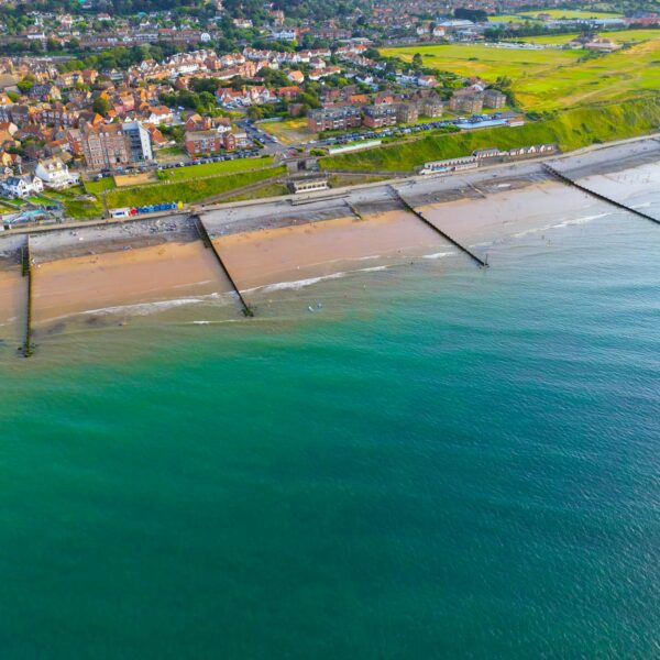 Vibrant aerial shot of Sheringham beach and town on a sunny day in Norfolk, England